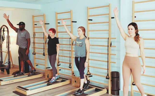 Four people exercising on side-by-side Core Align machines.