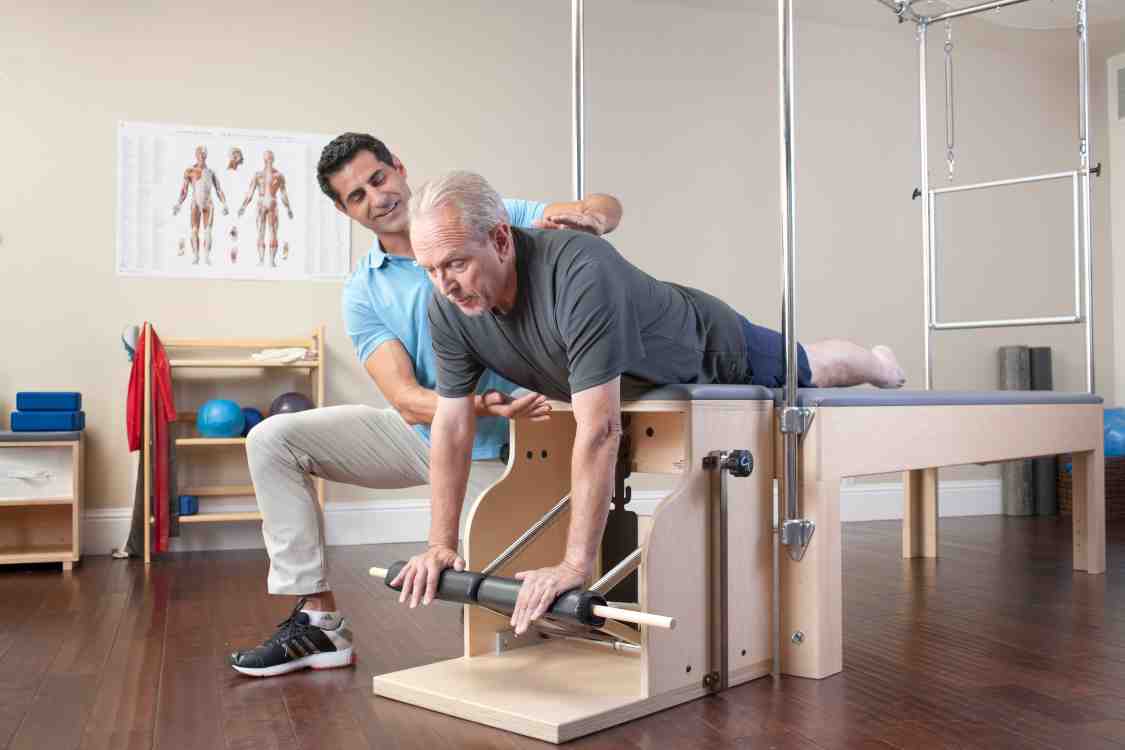 Man doing Pilates for rehabilitation